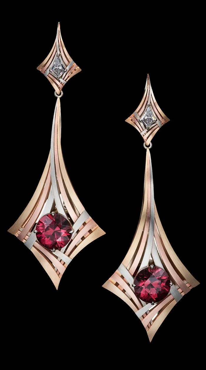 Rouge Moderne Earrings feature exotic red Zircons surrounded by three sweeping, architectural lines of gold and capped with kite shaped white diamonds_