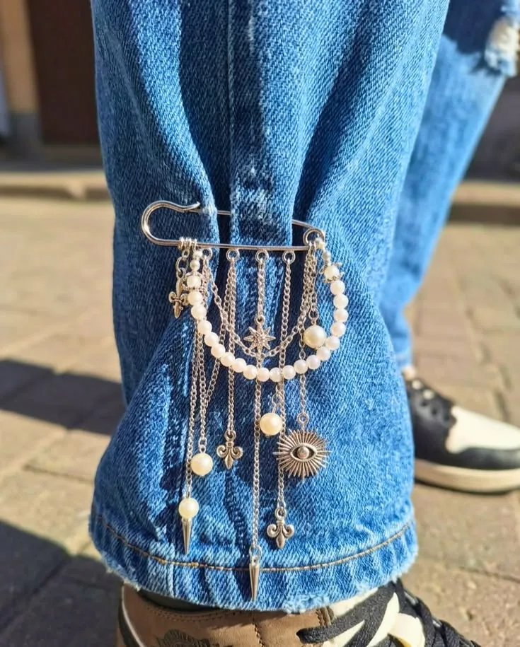 Stand out! A unique cascade pin with pearls, symbols and studs for your jeans_